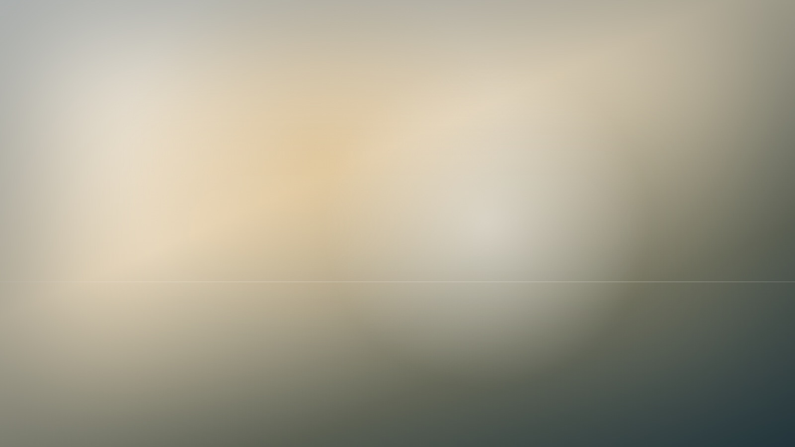A broad expanse of soft, even colour beneath a still and quiet sky.